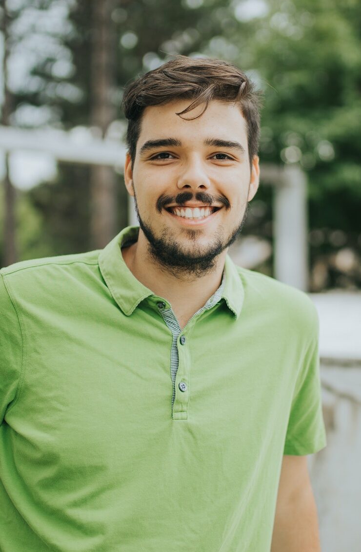 Young attractive Caucasian male smiling and posing outdoors